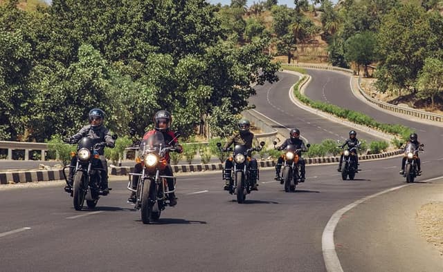 Person riding a dirt bike at sunset